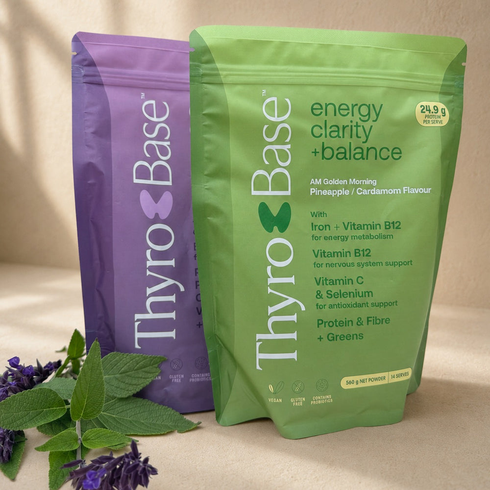 ThyroBase AM and PM pouches on warm sand in soft directional light.